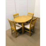 An extendable modern oval table with four matching chairs
