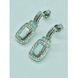 A pair of silver CZ and opal panelled earrings