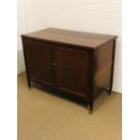 A large mahogany low deep cupboard with two inner shelves and brass handles and original keys (H84cm