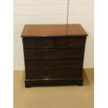 A small mahogany chest of drawers, two short drawers over three long drawers