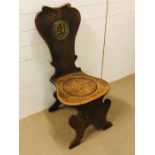 An oak Heraldic chair.