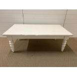 A white painted wooden coffee table with turned legs