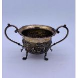 An Oriental two handled sugar bowl on four feet.