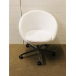A faux leather white swivel chair by Ikea