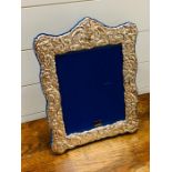 A large repousse silver plated photo frame (38cm x 30cm)