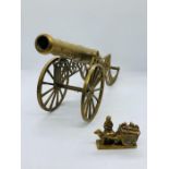 A brass cannon and a brass ornament