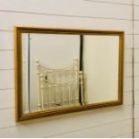 A gilt framed bevelled mirror (96cm x 64cm)