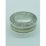 A Silver pill Box with enamel pictorial plaque to the inner lid