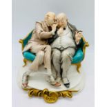 A Capodimonte figure of two old men.