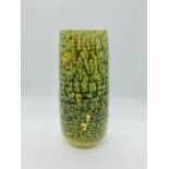 A green stoneware vase with gold accents (21cm) tall.