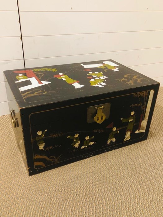 A hand painted Chinese wooden chest with brass fixings (H34cm D43cm W66cm)
