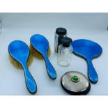 A selection of silver dressing table items to include enamelled mirror and brush, compact and