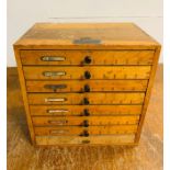 An eight drawer printing cabinet with metal letter blocks