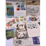 A small selection of First Day Covers, postcards and a book of film stars cigarette cards