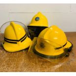 Three fireman helmets