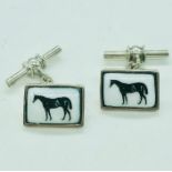 A pair of silver and enamel set cufflinks with horse motif.