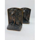 A pair of bronze dog theme book ends