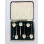 A set of six silver boxed coffee spoons with coffee bean handles