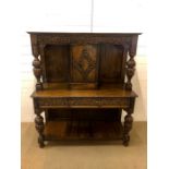 A Victorian/Edwardian carved oak chiffonier with three drawers and central cupboard