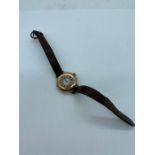 A 9ct gold Ladies watch on brown leather strap