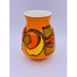 A Poole pottery vase, in characteristic vibrant red, orange and yellow