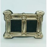 A silver double picture frame with easel back