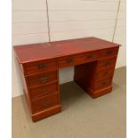 A pedestal desk with brass dropped down handles (H75cm W123cm D58cm)