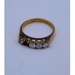 An 18 ct gold five stone ring with a stone missing (2.8g)