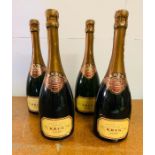 Four bottles of Krug Grand Cuvee Champagne.