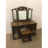 A carved oak Jacobethan dressing table with matching stool