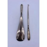 Silver handled hallmarked button hook and shoe horn.