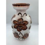 A Studio Pottery vase with a floral theme.