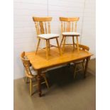 A beech kitchen table with removable legs and four farmhouse beech chairs