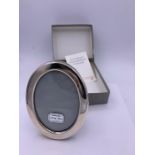 A Concorde Hallmarked silver oval picture frame in original box.