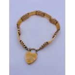 A 9ct gold gate bracelet with heart shaped fastener (22.5g)