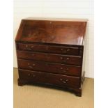 A mahogany writing bureau with four drawers