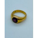 A Persian Gold signet ring with central red stone (12.7g)