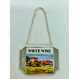 A silver plated and enamel wine bottle label "White Wine"