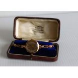 A cased mid-20th century ladies manual dress wristwatch with Arabic numerals in a 9ct gold case,