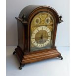 A late Victorian oak and brass dial bracket clock for Morath Bros., Liverpool, the arched dial