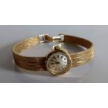 A mid-20th century Omega ladies dress watch with baton numerals, a 9ct yellow gold bark strap and