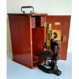 An early cased Bausch & Lomb 77116 cased monocular microscope with some accessories retailed by