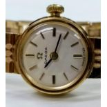 A mid 20th century ladies dress watch by Omega with 9ct yellow gold case and strap, in working