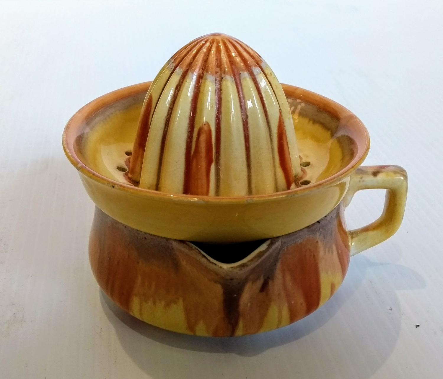 A Shelley dripware lemon squeezer and jug glazed in tones of yellow and brown, printed mark to base,