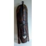 A Kenyan carved wooden tribal ceremonial mask, 77 cm H