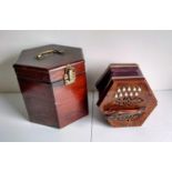 An early 20th century twenty-button concertina with pierced decoration, leather-trimmed paper