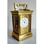 A brass carriage clock by Charles Frodsham, London, circular white dial with