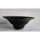 Dame Lucie Rie D.B.E (1902-1995) an iridescent black circular bowl, 7 x 18 cm, incised studio stamp