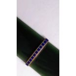 A Faberge-style nephrite page turner or letter opener with yellow metal and lapis lazuli band,