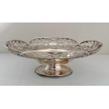 A George VI silver oval basket with elaborate pierced decoration on a raised base by Harrison